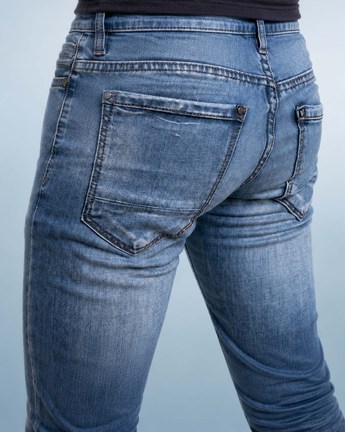 Athletic male low-rise jeans illustrating a compact lower gluteal contour